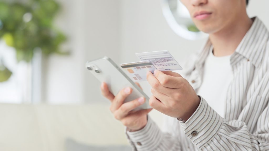 a young man using an ID scanner app to make a copy of his ID cards
